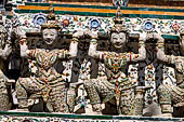 Bangkok Wat Arun - the distinctive decorations and the statues of the mythical  demon bears  that support the different levels of the prang. 